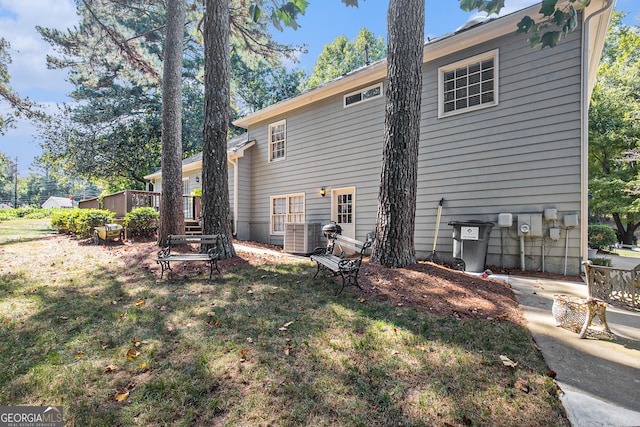 rear view of property featuring a yard and a patio area