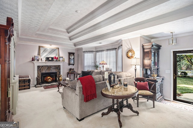 carpeted living room featuring a textured ceiling, crown molding, a fireplace, and a raised ceiling