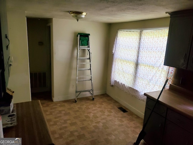 interior space with a textured ceiling