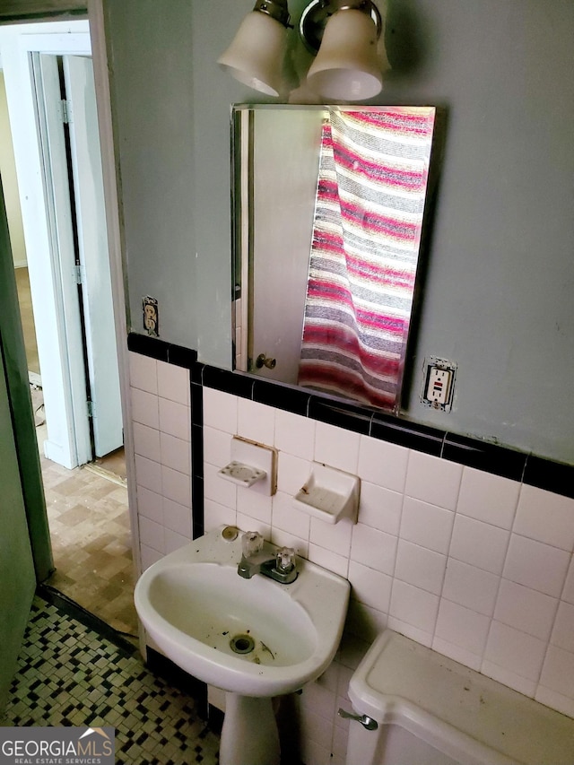 bathroom with wood-type flooring and tile walls