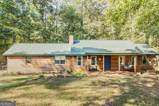 single story home featuring a porch and a front yard