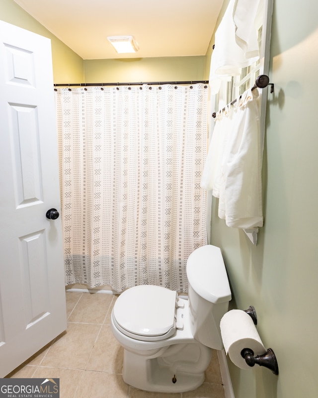 bathroom with tile patterned floors and toilet