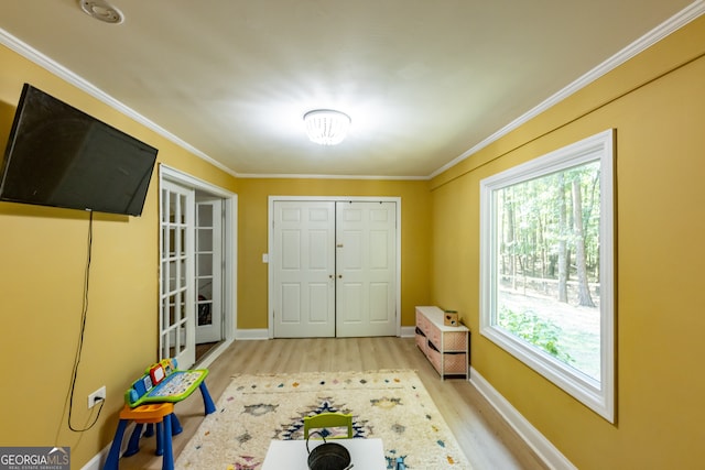 interior space featuring crown molding and light hardwood / wood-style floors