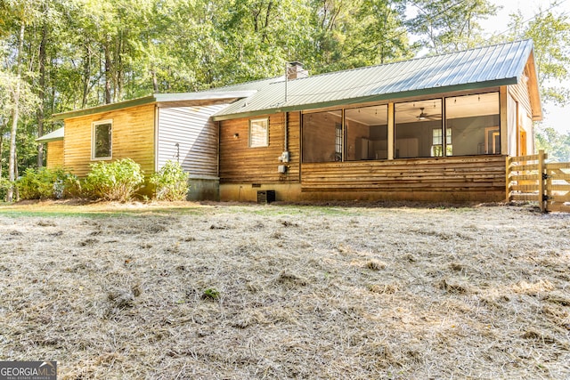 rear view of house featuring a sunroom