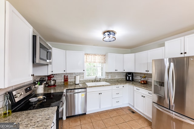 kitchen with white cabinetry, sink, light tile patterned floors, and stainless steel appliances