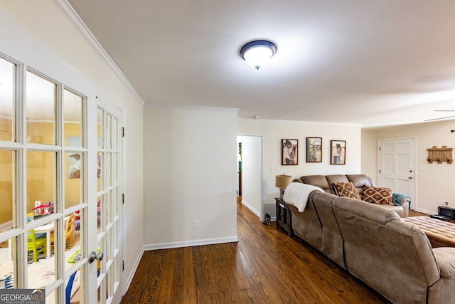 living room featuring dark hardwood / wood-style floors, ceiling fan, and ornamental molding