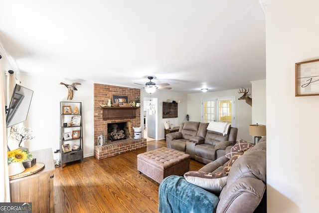 living room featuring a fireplace, hardwood / wood-style floors, and ceiling fan