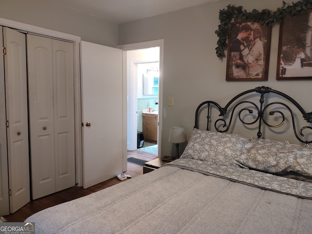 bedroom featuring dark wood-type flooring and a closet