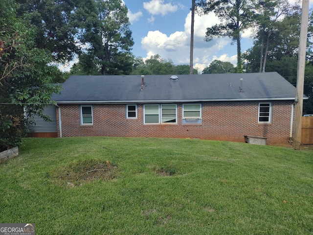 back of property featuring a lawn