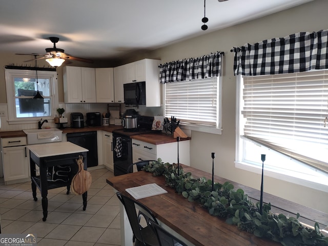 kitchen with ceiling fan, white cabinets, sink, black appliances, and wood counters