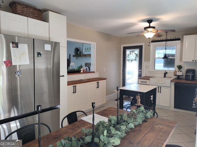 kitchen featuring ceiling fan, sink, white cabinetry, stainless steel refrigerator, and black dishwasher