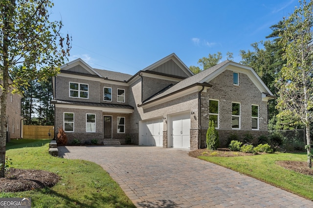 craftsman inspired home featuring a garage and a front lawn