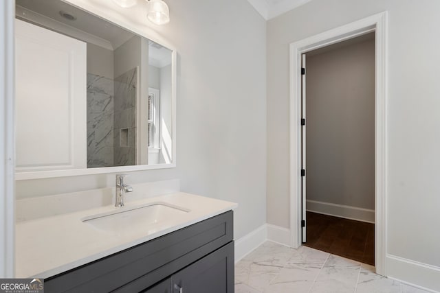 bathroom with vanity, crown molding, and tiled shower