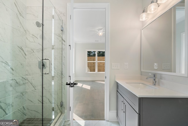 bathroom with ceiling fan, vanity, and a shower with shower door