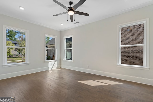 spare room with ornamental molding, dark hardwood / wood-style floors, and ceiling fan