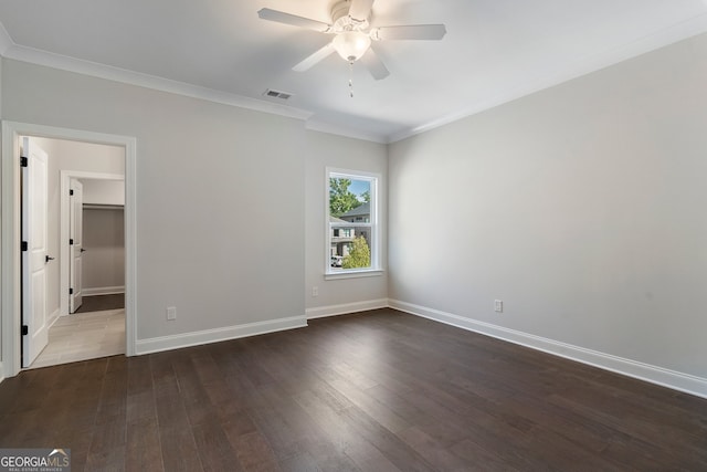 unfurnished room featuring ceiling fan, dark hardwood / wood-style floors, and ornamental molding