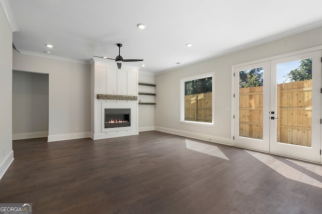 unfurnished living room with a fireplace, dark wood-type flooring, ceiling fan, and french doors