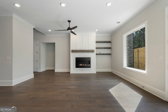 unfurnished living room featuring ceiling fan, a fireplace, dark hardwood / wood-style floors, and crown molding