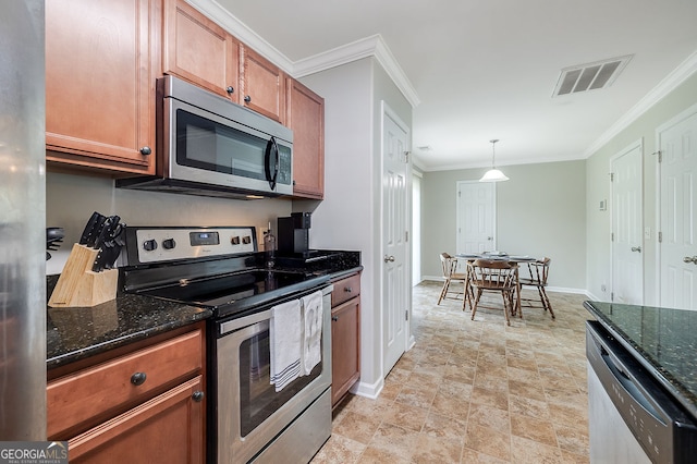 kitchen featuring dark stone countertops, pendant lighting, appliances with stainless steel finishes, and ornamental molding