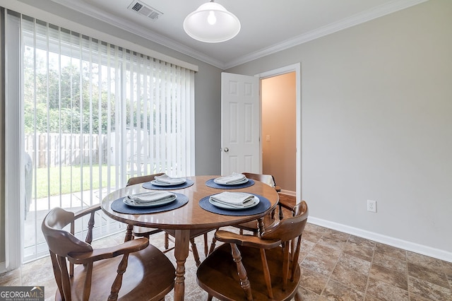 dining area featuring ornamental molding and a healthy amount of sunlight