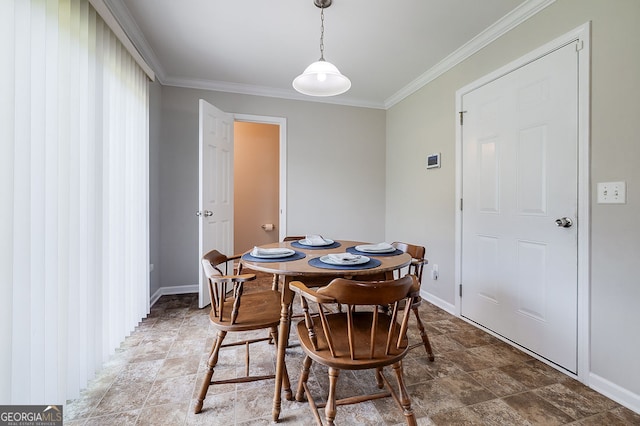 dining space with ornamental molding