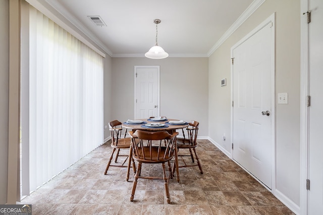 dining space with crown molding