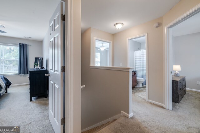 hallway with light carpet