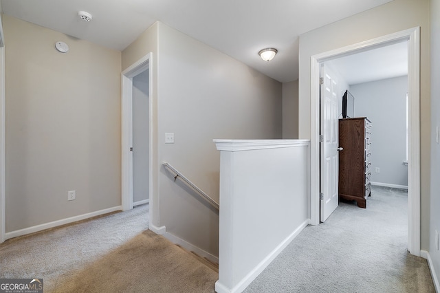 hallway featuring light colored carpet