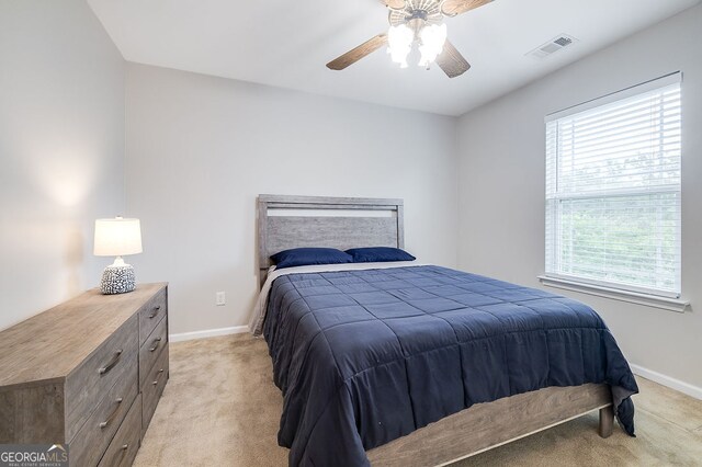 carpeted bedroom with ceiling fan