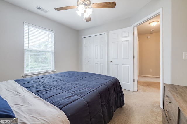 carpeted bedroom with a closet and ceiling fan