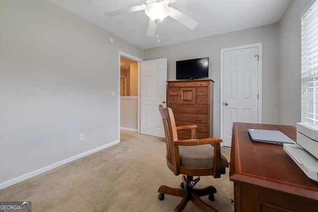 office space with ceiling fan and light carpet