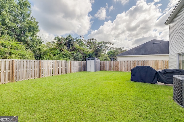 view of yard with a storage unit and central AC