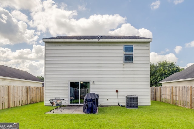 back of property with cooling unit, a yard, and a patio area