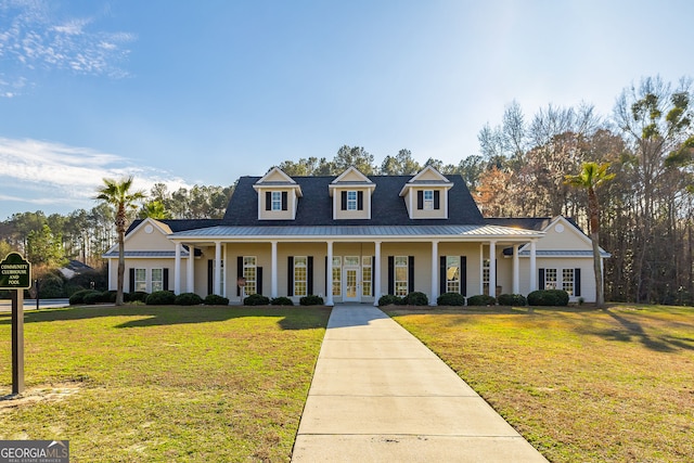 cape cod house featuring a front yard and a porch