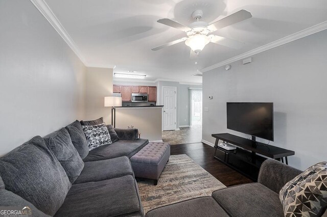 living room with ceiling fan, dark hardwood / wood-style floors, and crown molding