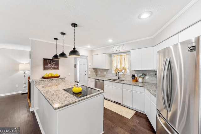 kitchen with white cabinets, appliances with stainless steel finishes, dark hardwood / wood-style floors, and a kitchen island