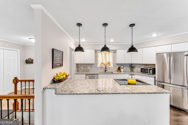 kitchen featuring dark hardwood / wood-style floors, sink, white cabinets, stainless steel appliances, and light stone countertops