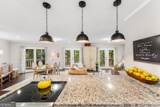 kitchen with french doors, hardwood / wood-style flooring, plenty of natural light, and ornamental molding