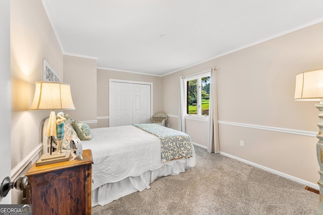 carpeted bedroom with ornamental molding and a closet