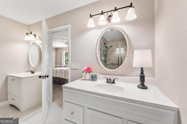 bathroom featuring walk in shower, vanity, and ceiling fan