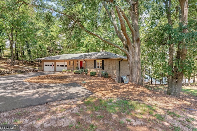 ranch-style home featuring a garage and covered porch