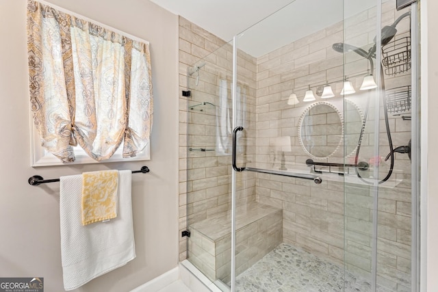 bathroom with a shower with shower door