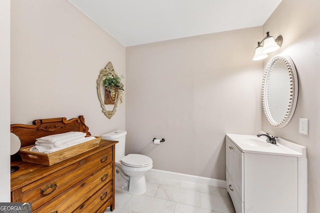 bathroom with vanity, toilet, and tile patterned floors