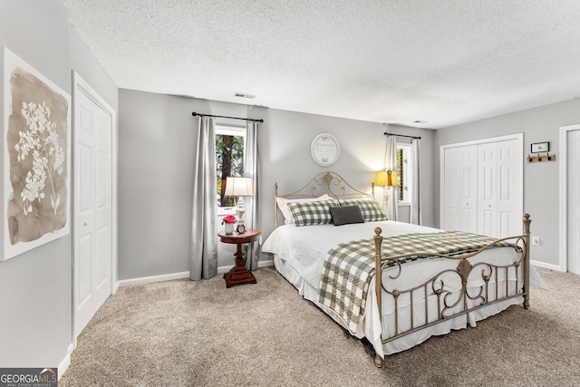 carpeted bedroom with a textured ceiling