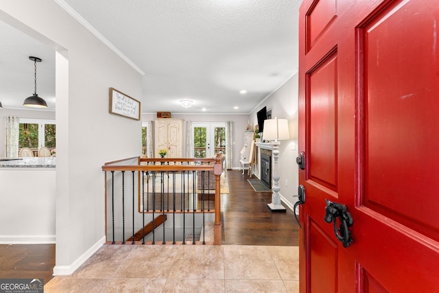 entrance foyer featuring ornamental molding, hardwood / wood-style floors, and plenty of natural light