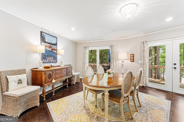 dining space featuring dark wood-type flooring, french doors, and plenty of natural light