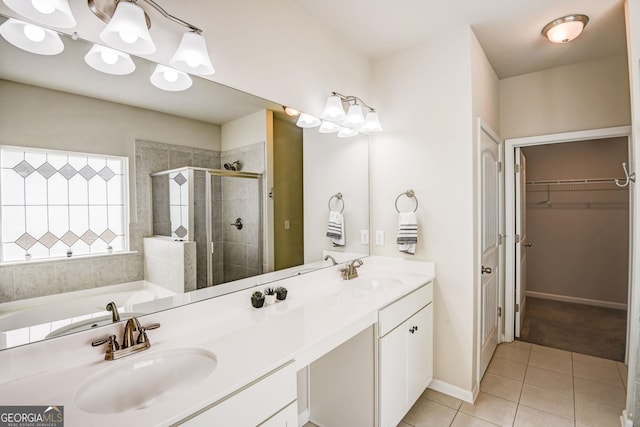 bathroom featuring independent shower and bath, vanity, and tile patterned floors