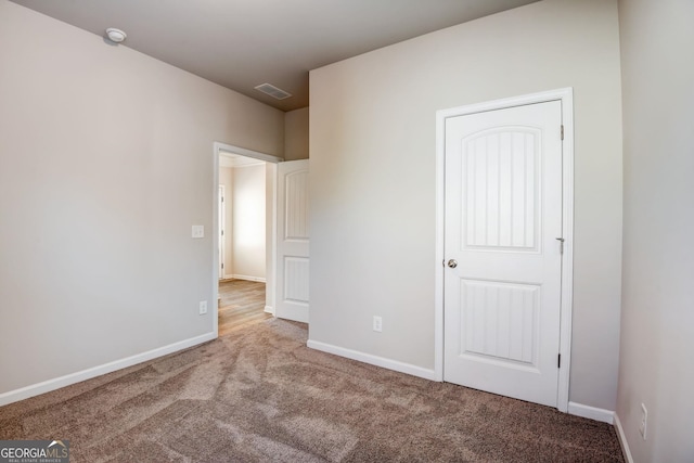 unfurnished bedroom featuring light carpet