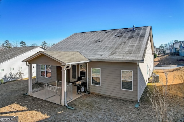 rear view of property with a patio and central air condition unit