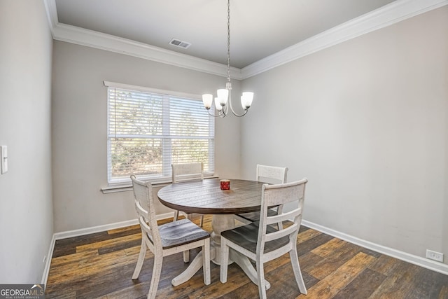 dining space featuring an inviting chandelier, crown molding, and dark hardwood / wood-style flooring